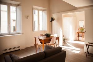 a living room with a table and a couch at Pietrapiana Boutique Apartments in Florence