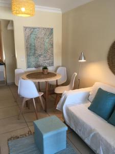 a living room with a couch and a table at Casas do Mar - Baleal 1 - Sea House in Baleal