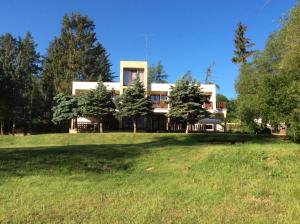a house with a large field in front of it at Pod hradem Cornštejn in Oslnovice +12 photos