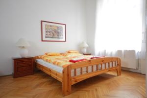 a bedroom with a large wooden bed in a room at Blue Rose Apartment in Budapest