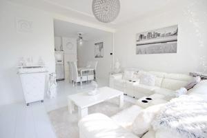 a white living room with a white couch and a table at White Luxury Penthouse in City Centre in Amsterdam