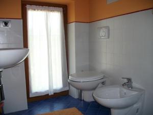 a bathroom with a white toilet and a sink at La Corte Di Langa in Albaretto Della Torre  +25 photos