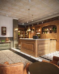 a large lobby with a large wooden reception desk at The Armstrong Hotel in Fort Collins