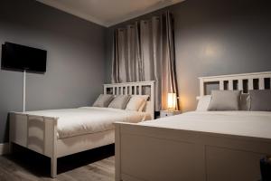 Postel nebo postele na pokoji v ubytování REM Hotel