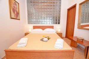 a bedroom with a bed and a table with two towels at House Nada in Rovinj