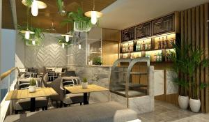 a restaurant with tables and chairs and a bar at Tori Prestige Bangkok Hotel in Bangkok