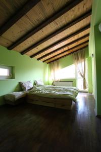 a bedroom with a bed and a large window at Ashkova House in Govedartsi