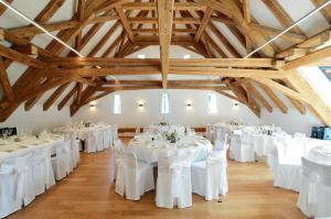 a room with white tables and white chairs at Bad Schauenburg in Liestal