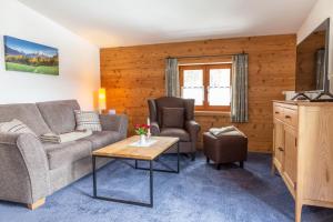 a living room with a couch and a table at Rostalm in Berchtesgaden