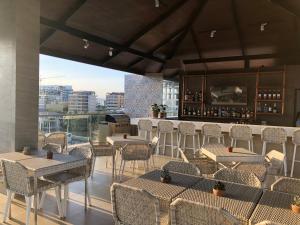 a restaurant with tables and chairs and a bar at Apollonia Royale Hotel in Angeles