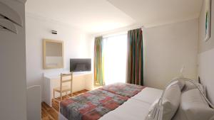 Postel nebo postele na pokoji v ubytování Hotel Erma