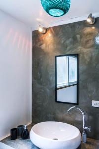 a bathroom with a sink and a mirror at Garden loft 90sqm in the heart of El Nido- 2 bedrooms in El Nido +32 photos