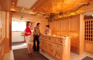 a group of people standing at a kitchen counter at All Inclusive Hotel Bachmayerhof in Uderns
