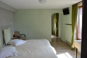 Un pat sau paturi într-o cameră la Logis Hotel Les Vosges