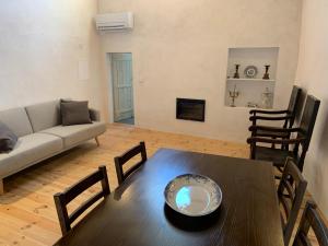 a living room with a table and a couch at Casa do Castelo in Castelo de Vide +14 photos