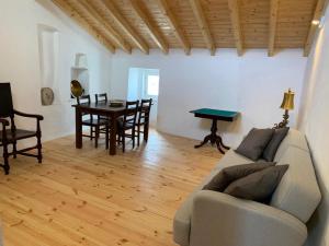 a living room with a couch and a table at Casa do Castelo in Castelo de Vide