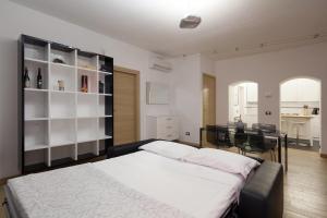 a bedroom with a large bed and a dining room at Appartamento Principe in Monterosso al Mare