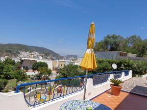 a yellow umbrella sitting on top of a balcony at Il Mediterraneo - Adults Only in Ponza