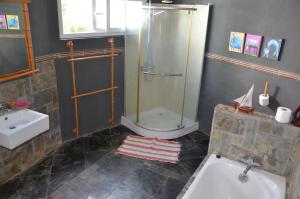 a bathroom with a shower and a sink at serin du cap in Blue Bay +7 photos