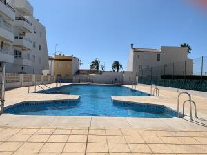 a swimming pool in the middle of a building at Paradise Beach in Caleta De Velez