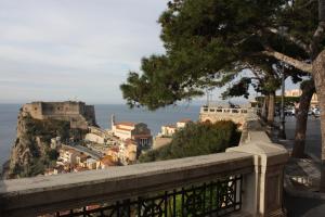 a view of a city from a balcony with the ocean at Gemma del Sud in Scilla
