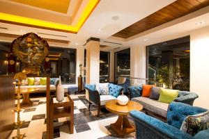 a living room with couches and a table at Divine Resort & Spa in Rishīkesh