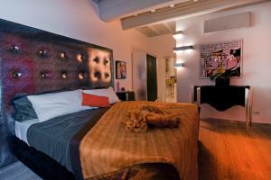 a bedroom with a large bed with a large headboard at Pantheon Relais in Rome