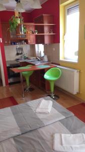a kitchen with green stools and a green counter top at Mediterrán Szállás in Gyula