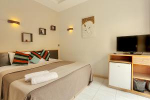 Кровать или кровати в номере L'Oiseau de L'Ocean Tourist Residence