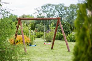 a swing set in a yard with grass at Nad Bugiem in Hrubieszów +3 photos