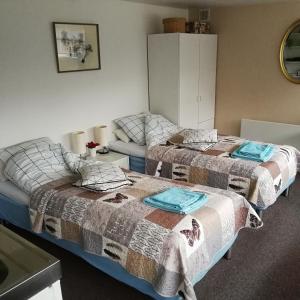 a room with two beds and a couch at Risskov Bellevue Guesthouse in Aarhus
