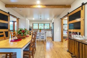 a kitchen and dining room with a table and chairs at Little Mountain Retreat in Caloundra