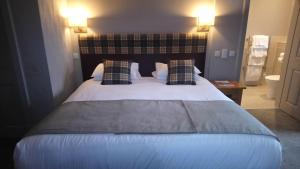 a hotel room with a bed and two nightstands at Benleva Hotel in Drumnadrochit
