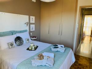 A bed or beds in a room at Blue Elegance City Center Heraklion Apartment