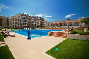 a swimming pool in front of a large building at Atia Resot in Chernomorets