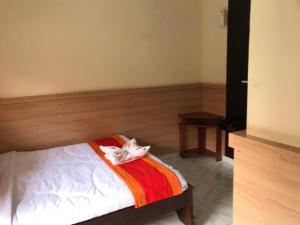 Postel nebo postele na pokoji v ubytování Agus Beach Inn