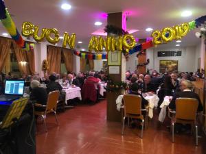 a group of people sitting at tables in a banquet hall at Hotel Arma Ristorante in Arma di Taggia