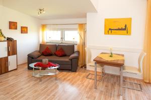 a living room with a couch and a table at Haus Lindenfeld in Ruhstorf