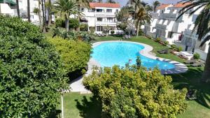 Výhľad na bazén v ubytovaní Confortable apartamento en los Cancajos alebo v jeho blízkosti