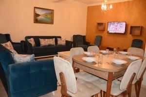 a living room with a table and chairs at Şar Pansiyon in Istanbul