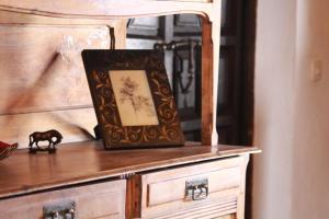 a wooden dresser with a picture on top of it at Posada del Castaño in Castaño de Robledo