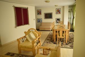 a living room with a table and chairs at Almudena Apart Hotel in La Paz