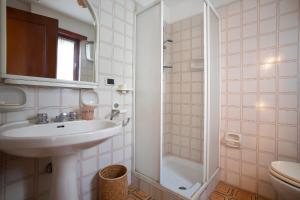 a bathroom with a sink and a shower at Villa summertime walking distance from the sea with garden in Fregene +15 photos