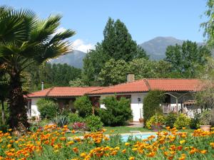 un jardín frente a una casa con flores en Mapuyampay Lodge Gastronómico en Santa Cruz