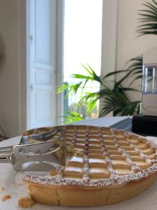 a pie sitting on top of a table with a spatula at PrimoPianoPosillipo in Naples