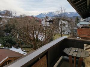 a balcony with a table and a view of mountains at Haus Pierzinger in Wörgl