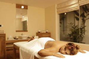 a naked woman laying on a bed in a bathroom at Riff Hikkaduwa in Hikkaduwa
