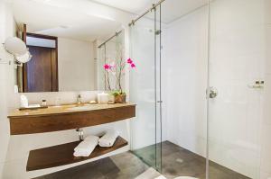 a bathroom with a glass shower and a sink at Hotel Morrison 114 in Bogotá