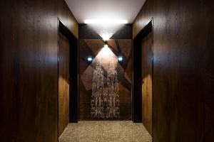 a hallway with wooden walls and a light on the wall at Amsterdam Hotel in Belgrade