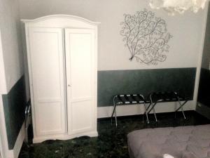 a bedroom with a bed and a white door at Gio&Gio little house in Genoa